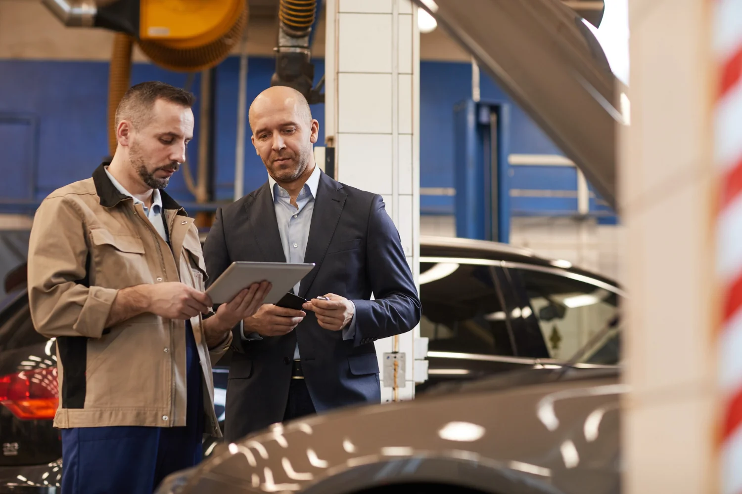 ASE Master Inspector checking car engine